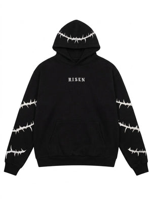 A black pullover hoodie with white barbed wire patterns printed on the hood, sleeves, and cuffs, featuring the word 'RISEN' in white gothic font on the chest.