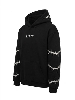 A black pullover hoodie with white barbed wire patterns printed along the sleeves and hood, featuring the word 'RISEN' in white gothic font on the chest.